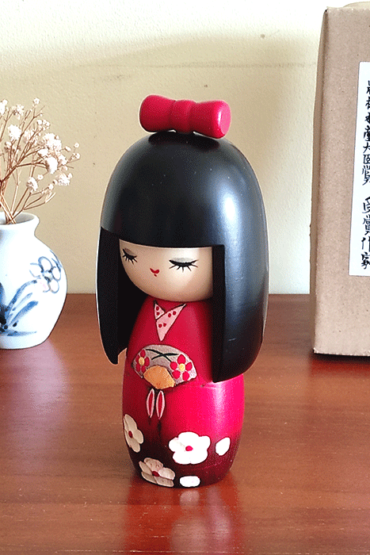 Kokeshi dollHandcrafted Japanese Kokeshi doll in traditional Sakura kimono, featuring intricate details and vibrant colors, perfect for cultural collectors and home decor Malta Mai
