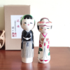 This 近代創作こけし modern creative Kokeshi doll is called '祝福 Shukufuku' and it was created by an award-winning artist  ‘関口東亜 Sekiguchi Toua‘. '祝福 Shukufuku' means 'celebration'.   The couple is wearing Japanese traditional wedding Kimono symbolizing love, unity, and cultural heritage.. Looking for a unique and meaningful gift for a couple who adores Japan? Why not choose '祝福 Shukufuku'? It's not just a gift; it's a gesture that celebrates love, tradition, and the artistry of Japan. Available at j-okini.com in Malta