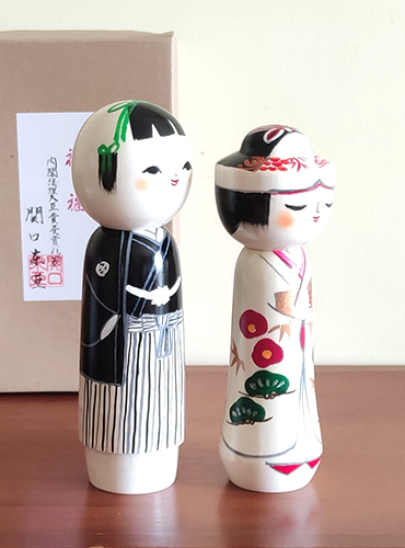 This 近代創作こけし modern creative Kokeshi doll is called '祝福 Shukufuku' and it was created by an award-winning artist  ‘関口東亜 Sekiguchi Toua‘. '祝福 Shukufuku' means 'celebration'.   The couple is wearing Japanese traditional wedding Kimono symbolizing love, unity, and cultural heritage.. Looking for a unique and meaningful gift for a couple who adores Japan? Why not choose '祝福 Shukufuku'? It's not just a gift; it's a gesture that celebrates love, tradition, and the artistry of Japan. Available at j-okini.com in Malta