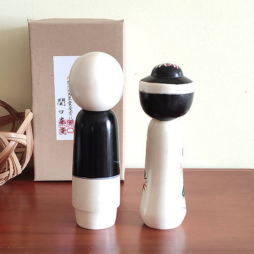 This 近代創作こけし modern creative Kokeshi doll is called '祝福 Shukufuku' and it was created by an award-winning artist  ‘関口東亜 Sekiguchi Toua‘. '祝福 Shukufuku' means 'celebration'.   The couple is wearing Japanese traditional wedding Kimono symbolizing love, unity, and cultural heritage.. Looking for a unique and meaningful gift for a couple who adores Japan? Why not choose '祝福 Shukufuku'? It's not just a gift; it's a gesture that celebrates love, tradition, and the artistry of Japan. Available at j-okini.com in Malta