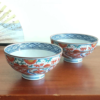 Handcrafted in the renowned pottery region of Arita, Japan, this bowl showcases the traditional Aka-e technique, a style known for its vibrant use of red, green, and blue hues.  The intricate design combines delicate floral motifs with geometric patterns, while the rim is beautifully accented with navy blue detailing, adding a layer of sophistication to the piece. Available at j-okini.com in Malta