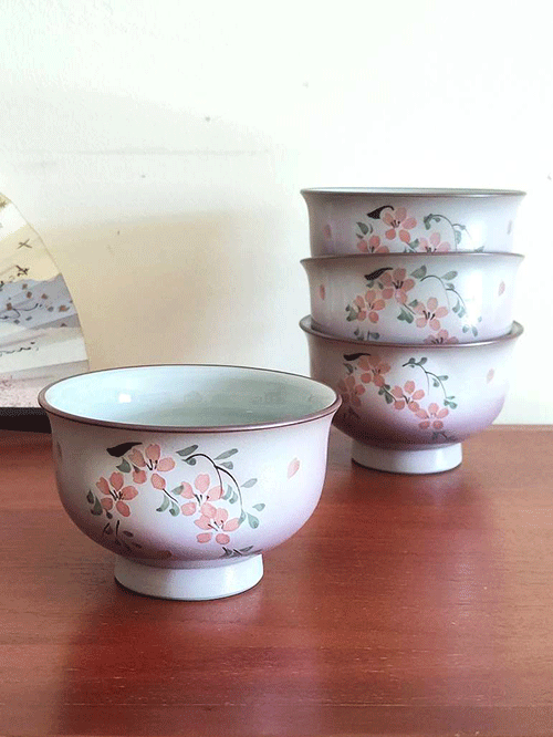 This exquisite teacup features delicate cherry blossoms and leaves painted on the front, with soft, pale purplish-pink hues and scattered Sakura petals adorning the entire surface. A true blend of elegance and tradition, this cup is perfect for both everyday use and as a decorative piece. Available at j-okini.com in Malta