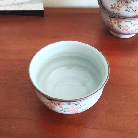 This exquisite teacup features delicate cherry blossoms and leaves painted on the front, with soft, pale purplish-pink hues and scattered Sakura petals adorning the entire surface. A true blend of elegance and tradition, this cup is perfect for both everyday use and as a decorative piece. Available at j-okini.com in Malta