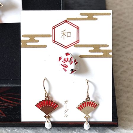 A set of Kitsune mask earrings and a pair of fan earrings. Available at j-okini.com in Malta