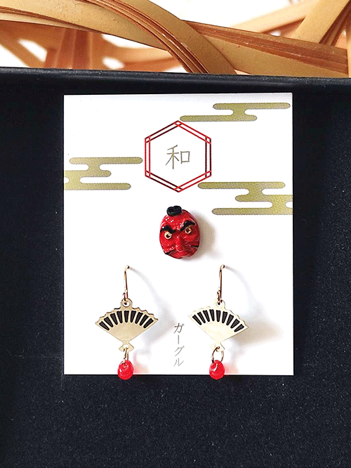 These unique earrings feature a set of three pieces, including a pair of fan-shaped earrings and a single Japanese festival mask Tengu earring inspired by traditional performing arts. Available at j-okini.com in Malta