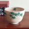 Kiyomizu-ware handmade Matcha bowl with green maple leaves painted on a warm beige base, inspired by Japan's early summer foliage. Buy it at j-okini in Malta.