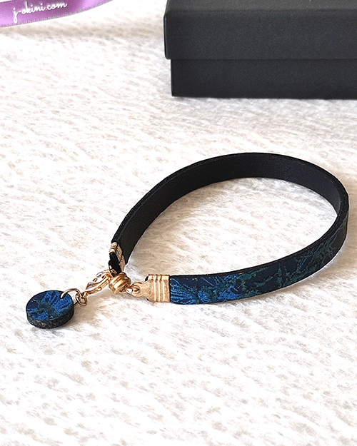 Ocean Twilight Japanese handmade leather bracelet with a textured deep blue and blue-green pattern, featuring a matching charm and magnetic clasp. Made in Japan. Gifts from Japan. j-okini.com in Malta