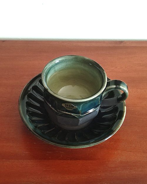 Handmade Kiyomizu Ware Coffee Cup and Saucer Set in deep Oribe green by Ando Mitsuru, showcasing texture contrasts and traditional Japanese craftsmanship.. Buy it from j-okini in Malta