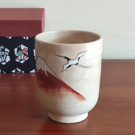 Kiyomizu-ware Yunomi tea cup featuring Red Fuji and crane design on a warm beige base with subtle orange-pink flecks. Available at j-okini.com in Malta