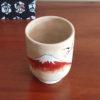 Kiyomizu-ware Yunomi tea cup featuring Red Fuji and crane design on a warm beige base with subtle orange-pink flecks. Available at j-okini.com in Malta