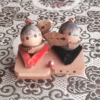 Vintage Wooden Dolls from the Showa Era. A pair of donguri dolls seated on wooden geta sandals, featuring hand-painted details and a mushroom accent.. Available at j-okini.com in Malta