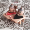 Vintage Wooden Dolls from the Showa Era. A pair of donguri dolls seated on wooden geta sandals, featuring hand-painted details and a mushroom accent.. Available at j-okini.com in Malta