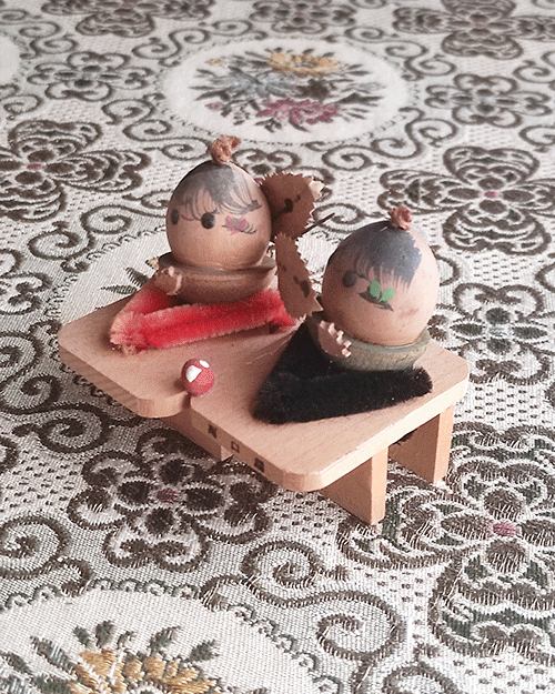 Vintage Wooden Dolls from the Showa Era. A pair of donguri dolls seated on wooden geta sandals, featuring hand-painted details and a mushroom accent.. Available at j-okini.com in Malta