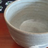 Kiyomizu-ware handmade matcha bowl with Hakeme brushstroke technique on a gray base, with white strokes and hints of light blue by artist Hiroki Shirai. j-okini.com in Malta