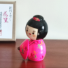 Kokeshi doll named Hanagasa by Sekiguchi Toua, wearing vivid pink kimono and holding an umbrella. j-okini.com in Malta