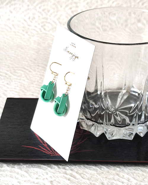 Handmade leather earrings with a delicate twist design in a traditional Japanese Hisui (jade green) color, showcasing Kyo-Yuzen dyeing craftsmanship. Gift idea from j-okini.com in Malta