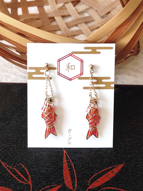 Handmade earrings in a shape of Koinobori - carp streamer. Three-dimensional design, each pair is painted in three vibrant, stained-glass-like colors red pink and orange. Available at j-okini.com in Malta