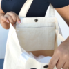 Miffy's slim canvas tote bag in white with a large Miffy illustration in black. button closure tote bag. Spacious tote bag. Japanese tote bag. Availabe at j-okini.com in Malta