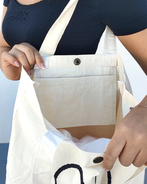 Miffy's slim canvas tote bag in white with a large Miffy illustration in black. button closure tote bag. Spacious tote bag. Japanese tote bag. Availabe at j-okini.com in Malta