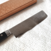 Japanese Nakiri kitchen knife with VG10 core, 16-layer Damascus wave pattern, and a rectangular shape, ideal for precise vegetable slicing and chopping.. Buy it from j-oini in Malta