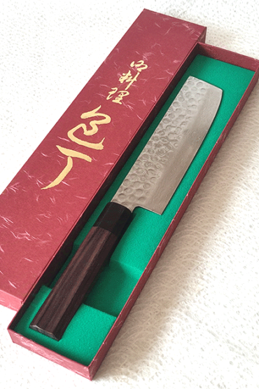 Handcrafted Japanese Nakiri kitchen knife with a hammered and wave-patterned AUS10 stainless steel blade, octagonal rosewood handle, and traditional craftsmanship. Available at j-okini in Malta