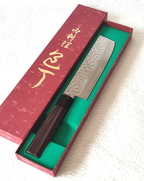 Handcrafted Japanese Nakiri kitchen knife with a hammered and wave-patterned AUS10 stainless steel blade, octagonal rosewood handle, and traditional craftsmanship. Available at j-okini in Malta