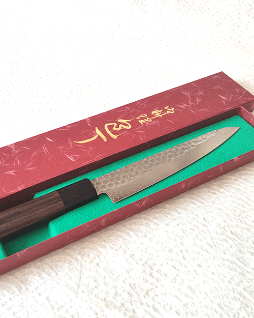 Japanese petty knife with a hammered AUS10 blade and octagonal Shitan rosewood handle. Available at j-okini in Malta