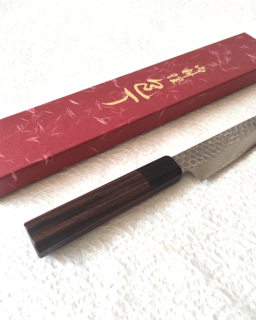 Japanese petty knife with a hammered AUS10 blade and octagonal Shitan rosewood handle. Available at j-okini in Malta