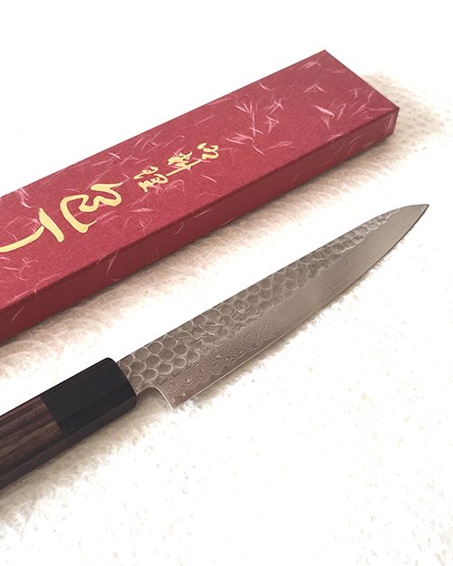 Japanese petty knife with a hammered AUS10 blade and octagonal Shitan rosewood handle. Available at j-okini in Malta