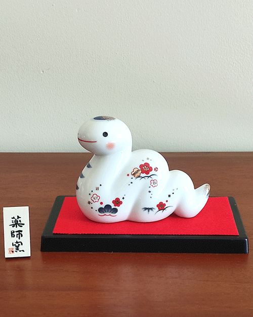 Porcelain Japanese Zodiac white snake figurine with a charming expression, decorated with pine, bamboo, and plum patterns, symbolizing prosperity and renewal. Buy at j-okini in Malta