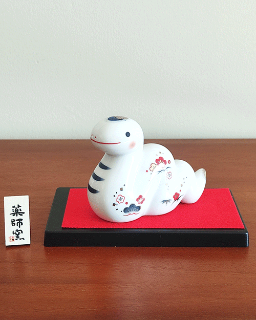 Porcelain Japanese Zodiac white snake figurine with a charming expression, decorated with pine, bamboo, and plum patterns, symbolizing prosperity and renewal. Buy at j-okini in Malta