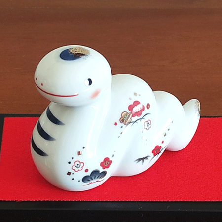 Porcelain Japanese Zodiac white snake figurine with a charming expression, decorated with pine, bamboo, and plum patterns, symbolizing prosperity and renewal. Buy at j-okini in Malta