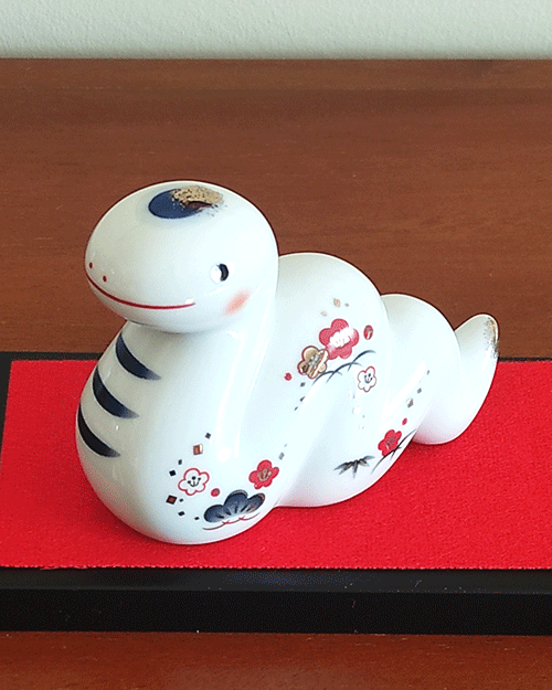 Porcelain Japanese Zodiac white snake figurine with a charming expression, decorated with pine, bamboo, and plum patterns, symbolizing prosperity and renewal. Buy at j-okini in Malta