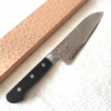 Japanese Santoku kitchen knife with a VG10 Damascus blade featuring a unique wave pattern and an elegant, simple handle. buy it at j-okini.com in Malta