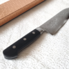 Japanese Santoku kitchen knife with a VG10 Damascus blade featuring a unique wave pattern and an elegant, simple handle. buy it at j-okini.com in Malta