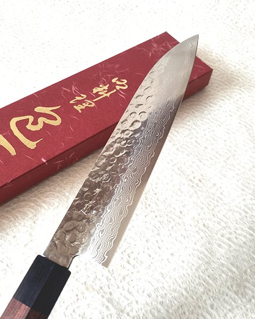 Japanese Santoku kitchen knife with hammered AUS10 blade and rosewood octagonal handle. Available at j-okini in Malta