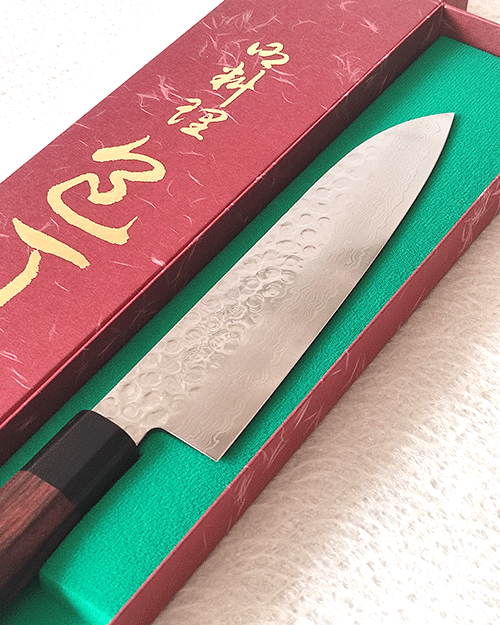 Japanese Santoku kitchen knife with hammered AUS10 blade and rosewood octagonal handle. Available at j-okini in Malta