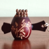 Vintage miniature Shichifukujin wooden doll on Tsutsumi from the Showa era. Features seven hand-painted lucky gods on a carved Tsutsumi with a 福 'luck' kanji and floral design. Available at j-okini.com in malta