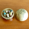 Vintage miniature wooden Shichifukujin doll set on a hand-painted boat with removable calligraphy lid, showing the Seven Lucky Gods with turnable heads. Antique Japan.