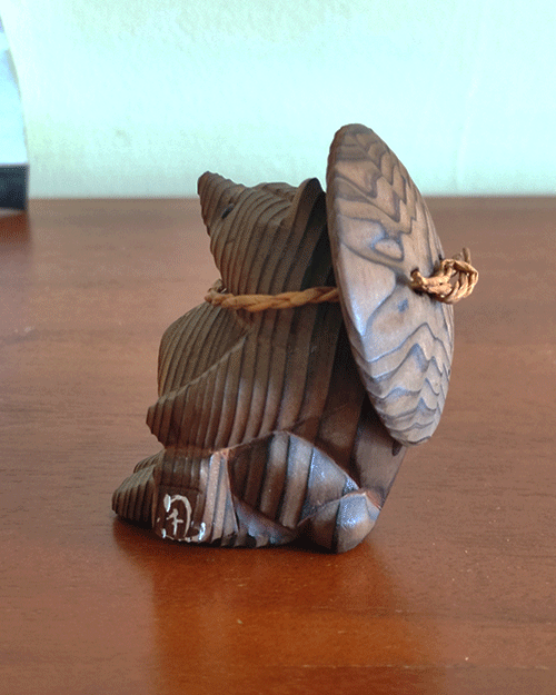 Vintage wooden tanuki (raccoon dog) figurine carved using the Ichii Itto Bori technique with removable hat, showcasing traditional Japanese craftsmanship and natural wood grain.