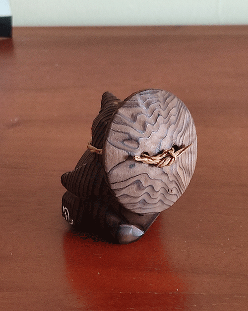 Vintage wooden tanuki (raccoon dog) figurine carved using the Ichii Itto Bori technique with removable hat, showcasing traditional Japanese craftsmanship and natural wood grain.