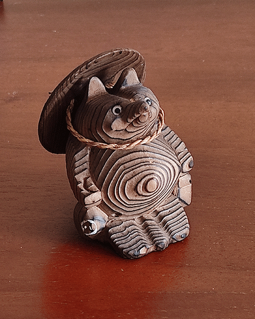 Vintage wooden tanuki (raccoon dog) figurine carved using the Ichii Itto Bori technique with removable hat, showcasing traditional Japanese craftsmanship and natural wood grain.