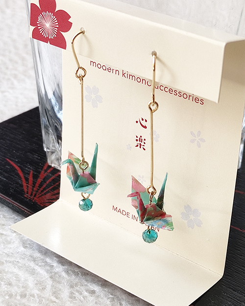 Elegant earrings featuring light blue Chiyogami paper with a Tsuru crane motif, accented by a light blue glass bead, symbolizing peace and longevity. Gift idea from j-okini.com in Malta