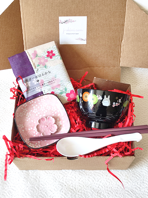 A beautifully packaged Totoro & Sakura gift box featuring a Totoro miso soup bowl, soup spoon, hexagonal chopsticks, sakura plate with matching chopstick rest, and a sakura-patterned double-sided gauze handkerchief.