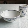 Banko-yaki Yunomi tea cup and rice bowl set in white Showcases elegant trailing vines with leaves in soft blue, encircling the cup and bowl in a flowing pattern. crafted by the Aigama kiln in Yokkaichi, Japan. Available at j-okini.com in Malta