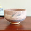 Kiyomizu-ware handmade Matcha bowl by Okayama Kousha, featuring a warm light coral and skin-tone hue with a delicate cracked-glass pattern. Tube-shaped for excellent heat retention, with unique random grey accents on the front. Stamped at the bottom. Made in Japan. Available at j-okini.com in Malta