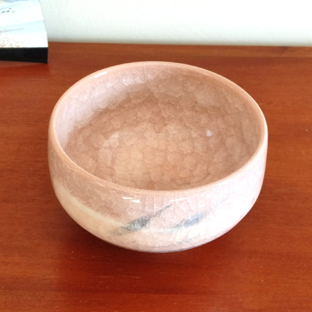 Kiyomizu-ware handmade Matcha bowl by Okayama Kousha, featuring a warm light coral and skin-tone hue with a delicate cracked-glass pattern. Tube-shaped for excellent heat retention, with unique random grey accents on the front. Stamped at the bottom. Made in Japan. Available at j-okini.com in Malta