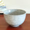 Kiyomizu-ware handmade Matcha bowl by Okayama Kousha, featuring a soft grey blend with a delicate cracked-glass pattern. Classic bowl shape for easy handling, stamped at the bottom. Made in Japan. Available at j-okini.com in Malta