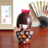 Handcrafted Japanese Kokeshi doll 'Kosode' by artist Kojo, wearing a chic brown kimono with a soft pink collar and a vibrant yellow obi. Available at j-okini.com in Malta