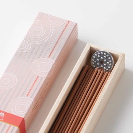 A beautifully packaged Kyoto incense set with a rare peach fragrance. The long incense sticks come with an incense stand, offering a fresh and sweet aroma reminiscent of ripe peaches. available at j-okini.com in Malta